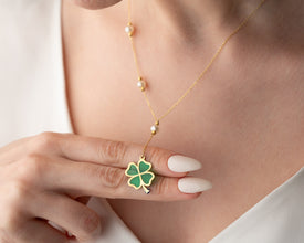 Model wearing symbolic silver necklace with charm