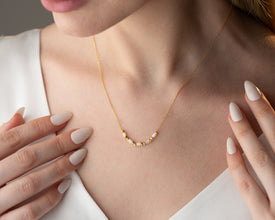Handmade minimalist necklace styled with neutral tones