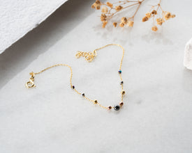 Minimalist bead bracelet styled with blazer and watch