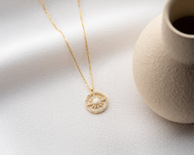 Handcrafted gold sun pendant necklace symbolizing hope, renewal, and positive energy.