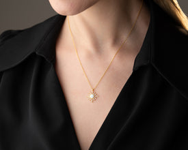 Astrology jewelry flat-lay featuring the celestial necklace with zodiac rings and constellation pendants.