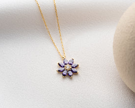Dainty flower charm necklace featuring a genuine amethyst gemstone in silver.