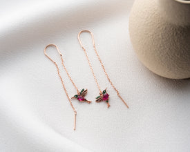 Nature-inspired earrings displayed in garden setting