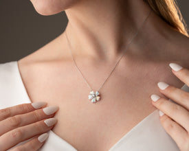 Boho-inspired botanical necklace crafted in sterling silver with an elegant glowing opal centerpiece.