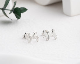 A modern and symbolic bird stud earring set in hypoallergenic sterling silver.