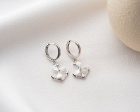 Earrings styled as part of a summer beach outfit