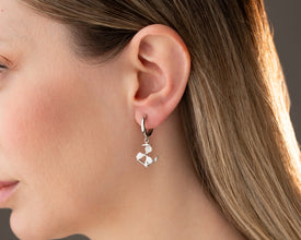 Close-up of sterling silver anchor and propeller charm