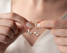 Lifestyle photo showing earrings in a beachside setting