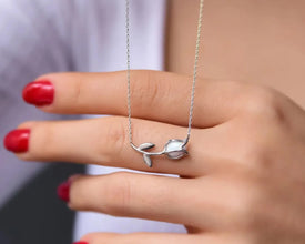 Silver floral pendant necklace, glowing opal gemstone accent