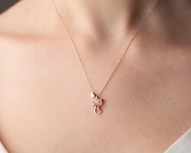 Closeup of sterling silver pink heart necklace flatlay