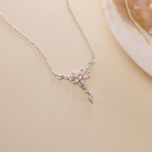 Delicate necklace with a pink floral pendant on a beige background