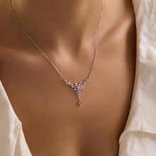 Necklace with a floral pendant on a person wearing a white blouse