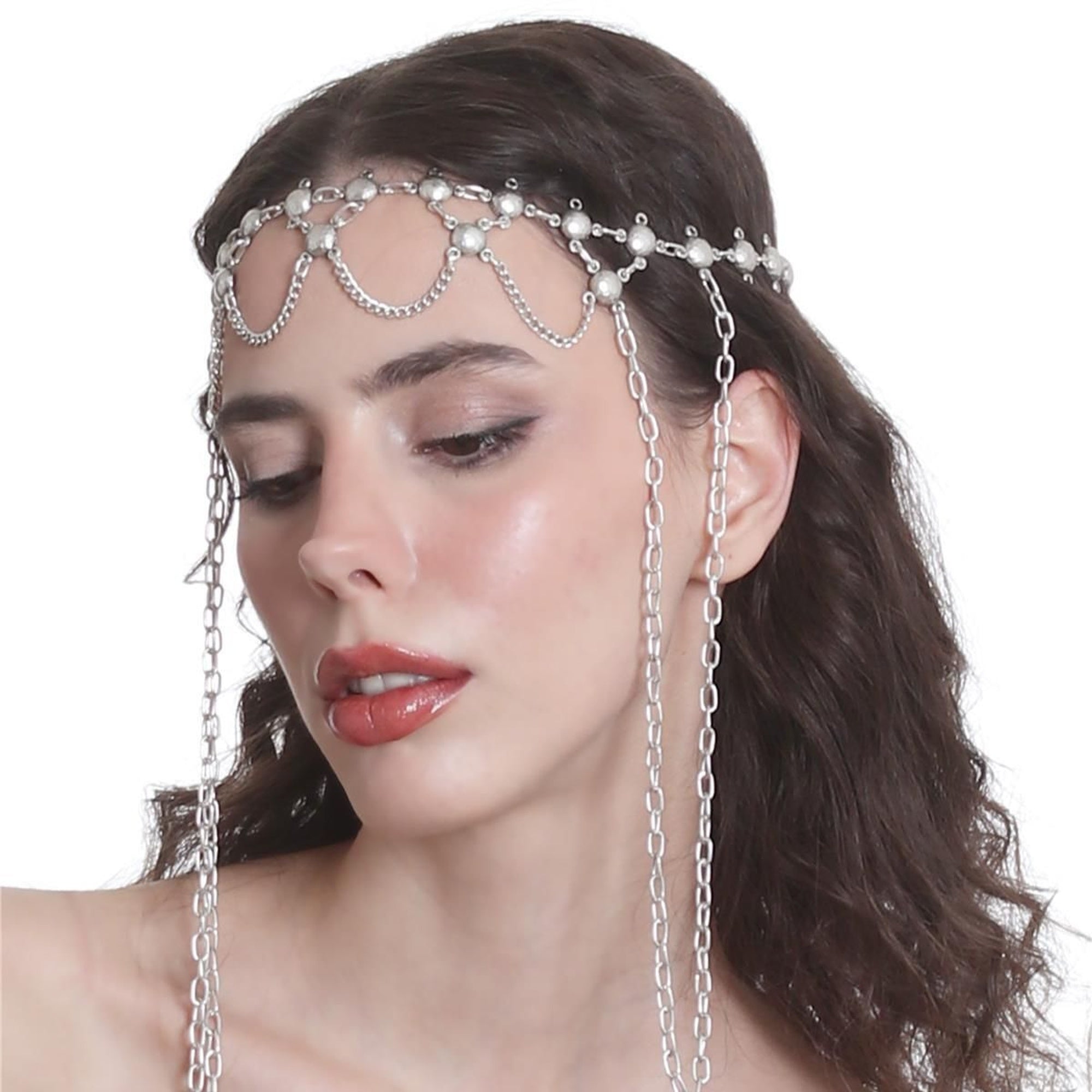 Woman wearing a silver chain headpiece with dangling chains on a white background