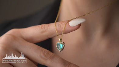 Minimalist aquamarine pendant with a delicate sterling silver heart charm.