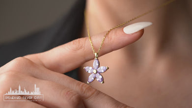 Minimalist sterling silver floral pendant with lilac petal details, perfect for layering.