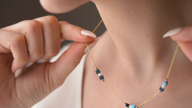 Model wearing geometric hematite necklace with neutral top