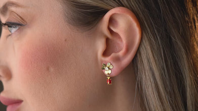 Model wearing ladybug earrings in a sunlit garden - perfect spring accessory