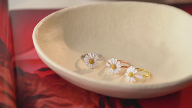 Bridesmaid proposal featuring daisy rings and fresh flowers