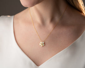 A handcrafted opal pendant necklace with botanical elegance, symbolizing renewal and transformation.
