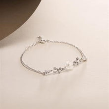 Silver bracelet with pearls on a beige background
