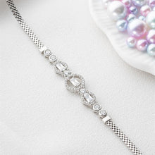 Silver bracelet with gemstones on a light gray background