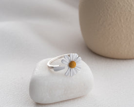 Self-care morning routine with coffee and daisy ring