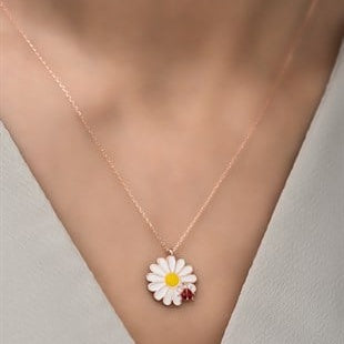 Necklace with a daisy pendant on a neutral background