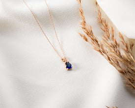 Oval sapphire pendant with a deep celestial blue gemstone for women.