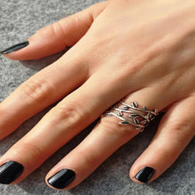 Close-up of a handcrafted silver leaf vine ring highlighting the engraved leaf details and smooth adjustable band.