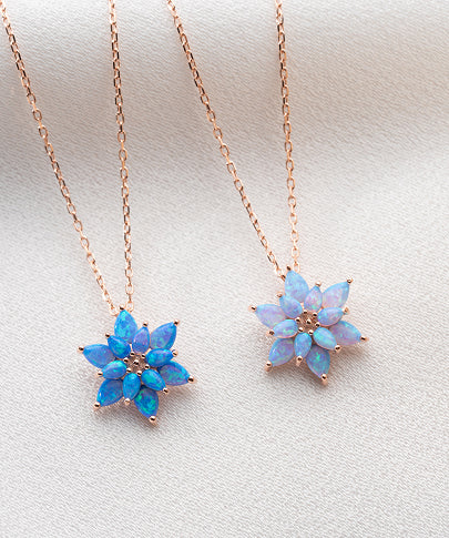 Sterling silver lotus necklace featuring a shimmering blue opal pendant, a minimalist spiritual gift for women who practice yoga or meditation.