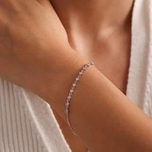 Silver bracelet on a person's wrist with a blurred background