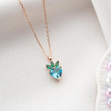 Necklace with a heart-shaped blue gemstone pendant on a light background