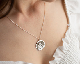 A beautiful handmade necklace featuring an engraved The Little Prince charm.