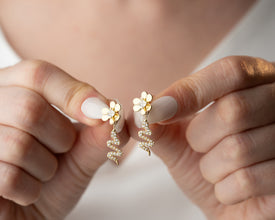 Size reference: bold serpent hoops compared to everyday objects