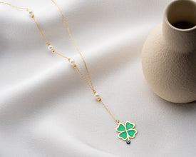 Flatlay of spiritual charm necklace on white cloth