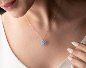 Yoga-inspired silver lotus necklace with a calming blue opal pendant