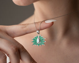 Elegant stained glass necklace displayed against a soft floral background, ideal for art lovers.