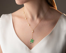 Layered silver necklace featuring fortune pendant