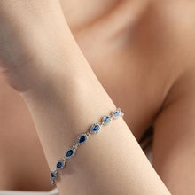 Silver bracelet with blue stones on a person's wrist