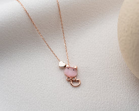 Close detail of handcrafted pink heart cat necklace
