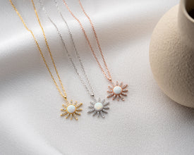 Sterling silver astrology-themed necklaces photographed on soft lighting for an elegant view.