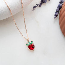 Necklace with a red strawberry pendant on a white background