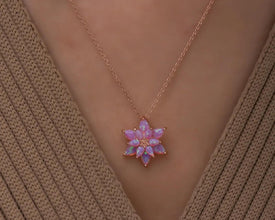Delicate pink opal gemstone pendant in a floral lotus design, ideal for spiritual seekers and nature lovers.