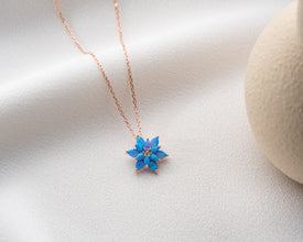 Minimalist lotus flower necklace with a delicate blue opal charm