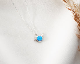 Handmade bird pendant featuring a delicate opal gemstone, crafted for everyday elegance.