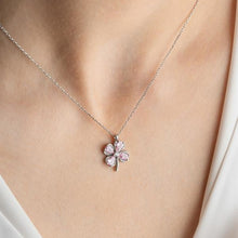 Necklace with a pink flower pendant on a person's neck