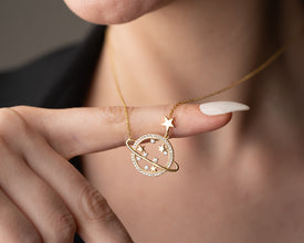The Saturn necklace displayed in an elegant gift box, ready to be presented as an astrology-themed present.