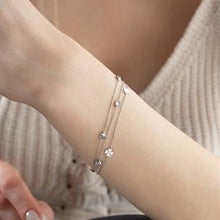 Silver bracelet on a wrist with a blurred background