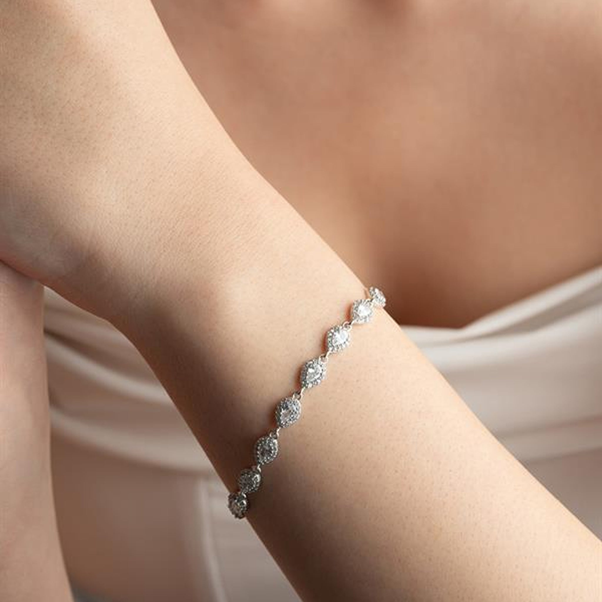 Silver bracelet on a person's wrist with a soft background
