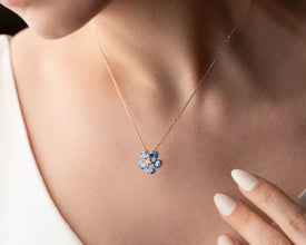 Gift-ready blue topaz flower pendant in premium box